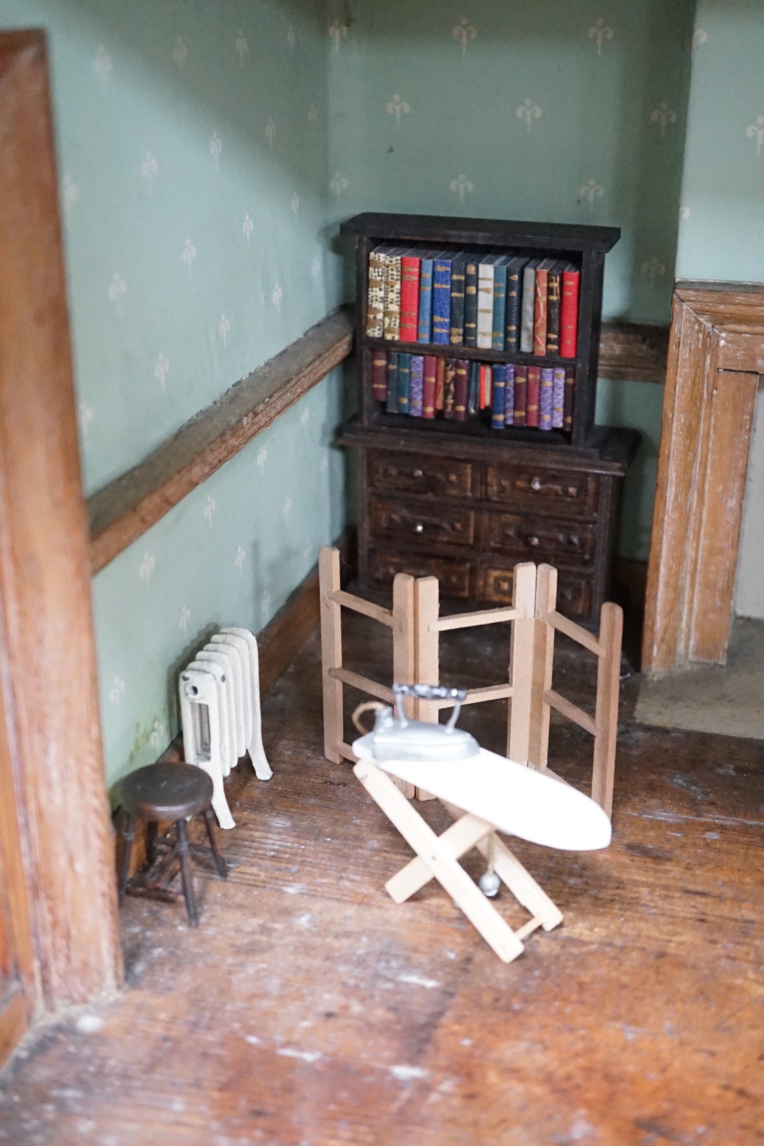 An early 19th century painted doll's house with block work facade enclosing a four room interior with central staircase, to be sold with assorted later furniture and accessories, width 117cm, depth 48cm, height with asso